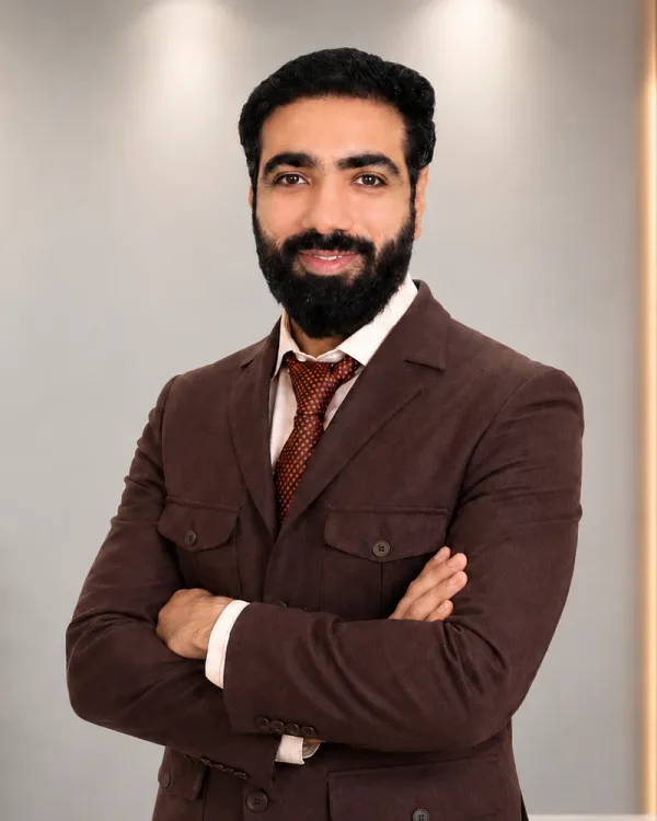 Chirag Kalra, founder of Wealthy Wave Accounting, standing in the office with his arms crossed